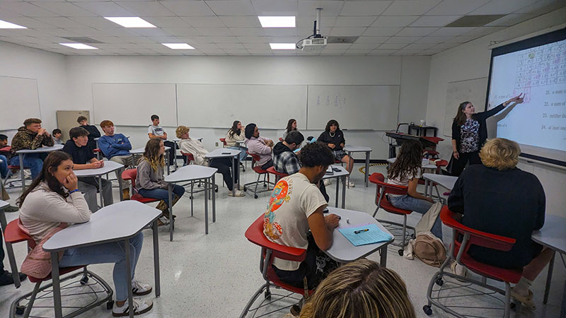 Students sitting at desks in classroom.