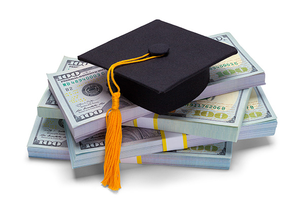 Graduate cap on a stack of money